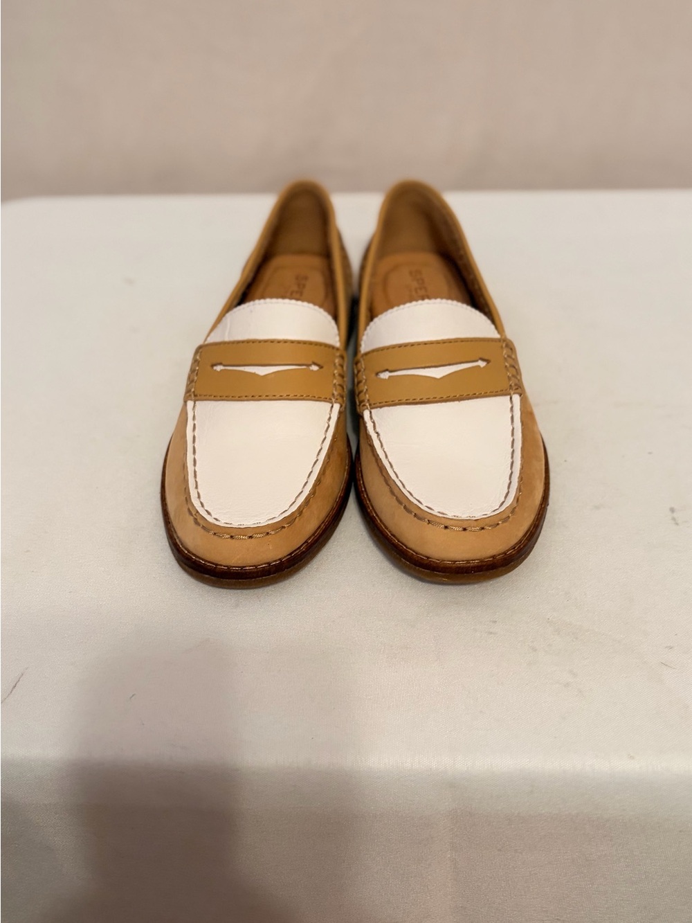 Sperry Seaport penny loafers in a beige and white two-tone leather